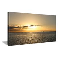 Scenic sunset over calm waters, showcasing vibrant hues and serene reflections.